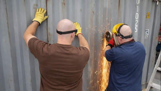 cutting into a shipping container